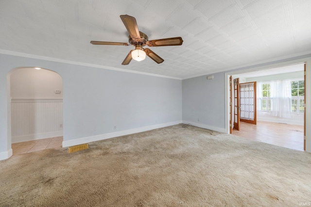 7404 N State Road 13, North Webster, IN 46555 - spare room featuring arched walkways, light colored carpet, ornamental molding, and a ceiling fan