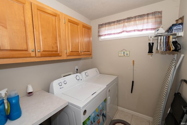 920 Cary Ct, South Bend, IN 46614 - laundry room featuring cabinet space, washing machine and clothes dryer, and tile patterned flooring