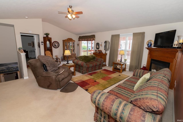 920 Cary Ct, South Bend, IN 46614 - carpeted living room with ceiling fan, lofted ceiling, and a glass covered fireplace