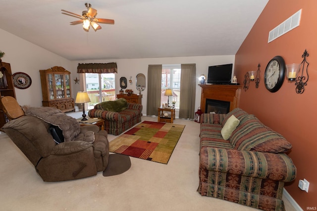 920 Cary Ct, South Bend, IN 46614 - carpeted living room featuring lofted ceiling, a ceiling fan, and a fireplace