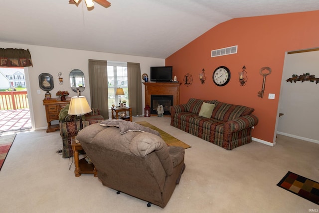 920 Cary Ct, South Bend, IN 46614 - carpeted living area with vaulted ceiling, a ceiling fan, and a fireplace