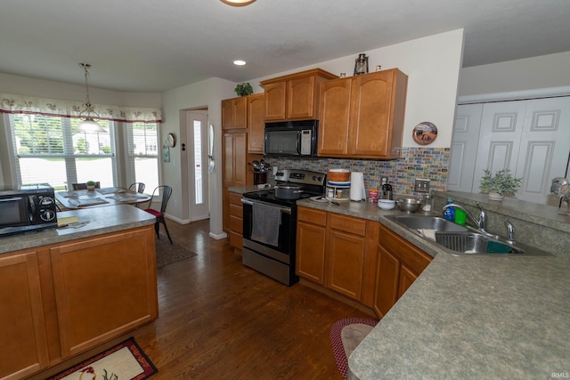 920 Cary Ct, South Bend, IN 46614 - kitchen with stainless steel range with electric stovetop, black microwave, dark wood finished floors, and brown cabinetry