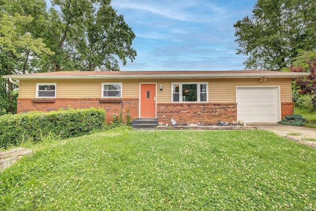 3121 S Yonkers St, Bloomington, IN 47403 - ranch-style house with brick siding, an attached garage, concrete driveway, and a front lawn