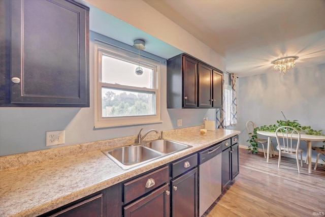 3121 S Yonkers St, Bloomington, IN 47403 - kitchen with dishwasher, light countertops, light wood finished floors, and dark brown cabinetry