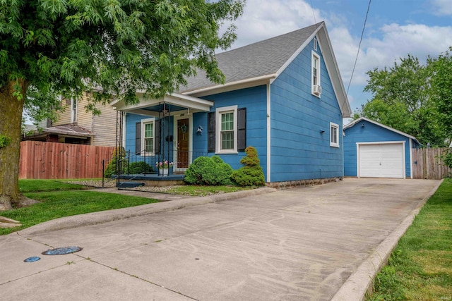 609 S Miller Ave, Marion, IN 46953 - view of front of house featuring an outdoor structure, a garage, concrete driveway, and a shingled roof