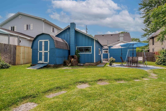 609 S Miller Ave, Marion, IN 46953 - rear view of property featuring a shed, board and batten siding, and a patio area