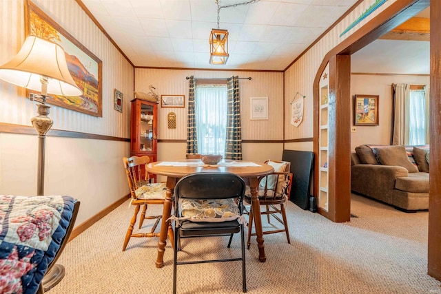 609 S Miller Ave, Marion, IN 46953 - carpeted dining space with plenty of natural light, crown molding, arched walkways, and wallpapered walls