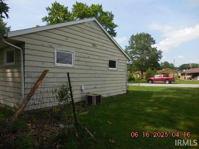 1608 Sunset Dr, Rochester, IN 46975 - view of side of property featuring a cooling unit and a lawn