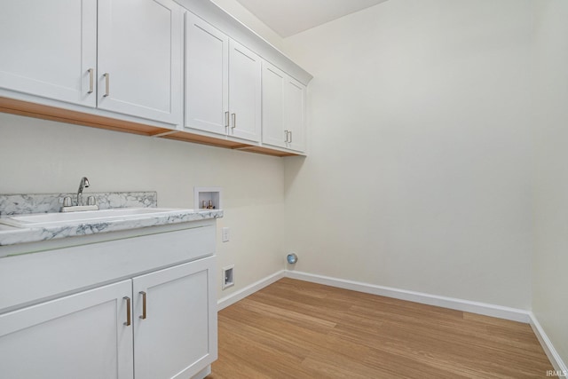54207 Starner Ave, Elkhart, IN 46514 - washroom with washer hookup, cabinet space, and light wood-style floors