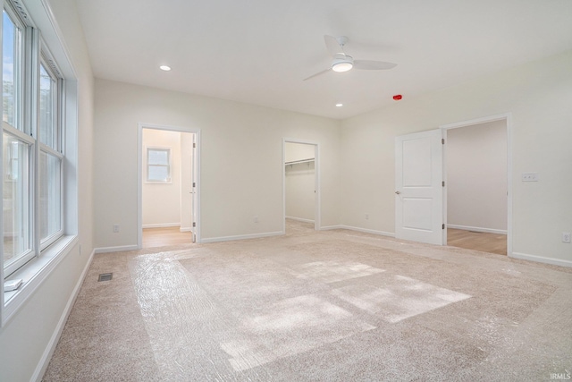 54207 Starner Ave, Elkhart, IN 46514 - unfurnished bedroom featuring light colored carpet, a walk in closet, recessed lighting, and a ceiling fan
