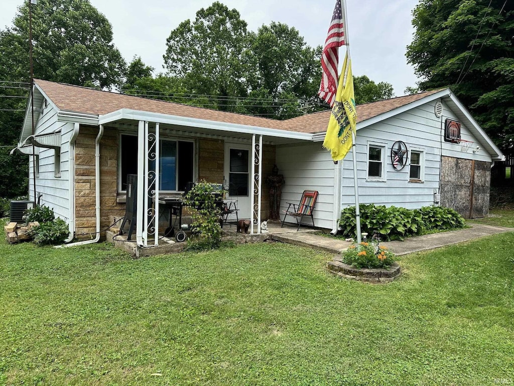 1165 Freeman Rd, Spencer, IN 47460 - view of front facade with a front lawn, a porch, stone siding, and roof with shingles