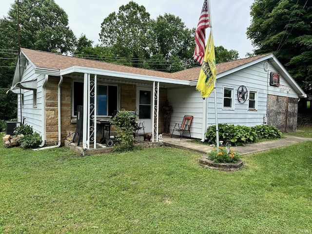 1165 Freeman Rd, Spencer, IN 47460 - view of front facade with a front lawn, a porch, stone siding, and roof with shingles