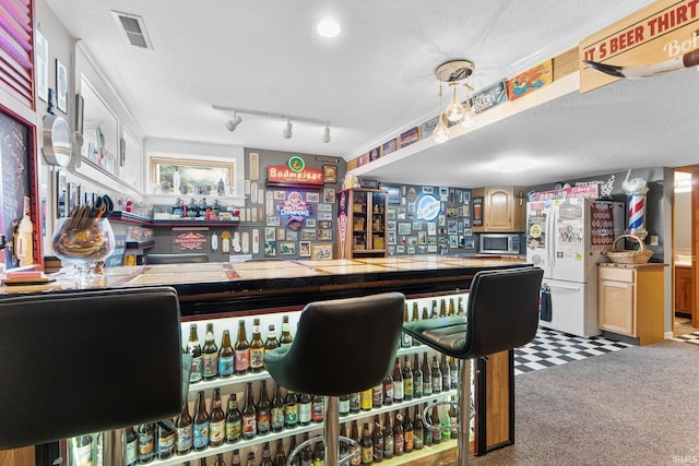 1321 Lost Lock Way, New Haven, IN 46774 - indoor dry bar featuring freestanding refrigerator, stainless steel microwave, and carpet