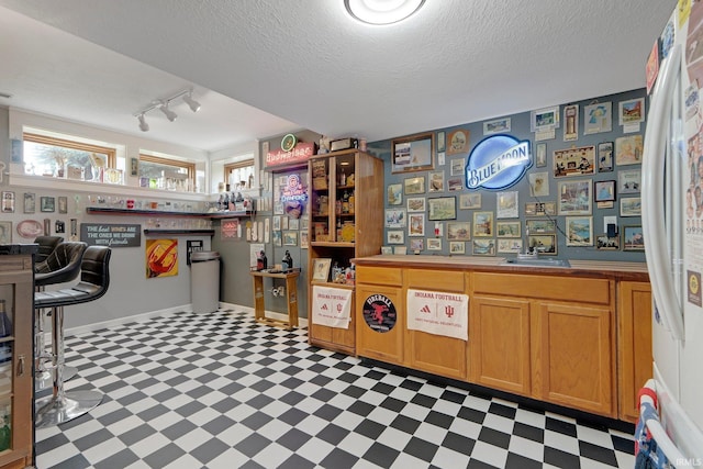 1321 Lost Lock Way, New Haven, IN 46774 - kitchen with tile patterned floors, rail lighting, and a textured ceiling