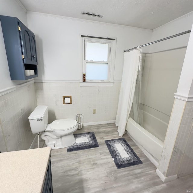 125 Ruby Rd, Attica, IN 47918 - bathroom with wood finished floors, vanity, ornamental molding, shower / tub combo with curtain, and tile walls