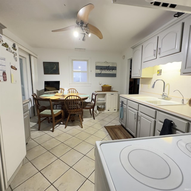 125 Ruby Rd, Attica, IN 47918 - kitchen featuring gray cabinets, light tile patterned flooring, a ceiling fan, freestanding refrigerator, and light countertops