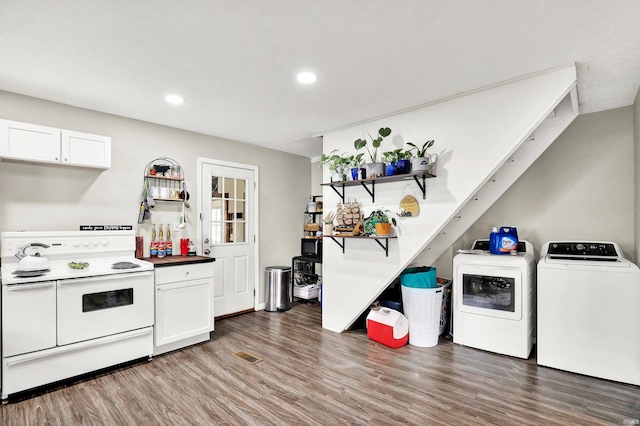 26 E Plum St, Anderson, IN 46012 - kitchen featuring double oven range, separate washer and dryer, wood finished floors, open shelves, and white cabinetry