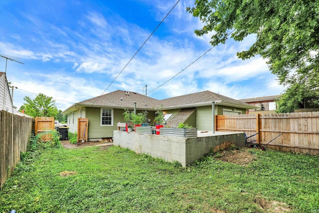 26 E Plum St, Anderson, IN 46012 - back of house with a fenced backyard and a shingled roof