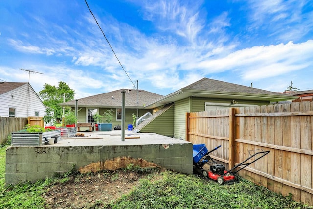 26 E Plum St, Anderson, IN 46012 - rear view of house with a shingled roof and a garden