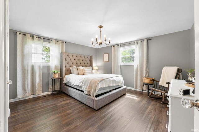 6830 County Road 40, Butler, IN 46721 - bedroom with dark wood-style floors and a chandelier