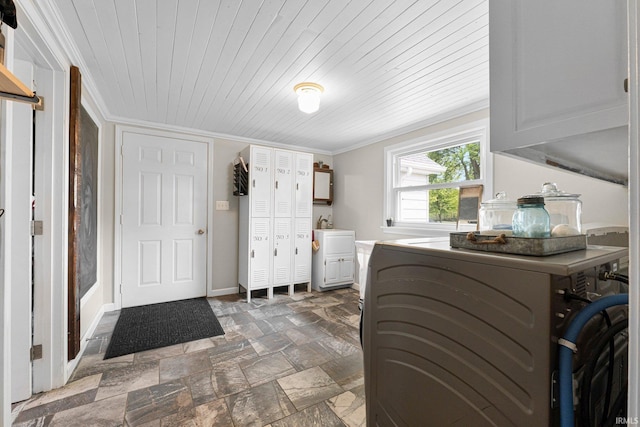 6830 County Road 40, Butler, IN 46721 - washroom featuring cabinet space, washer and clothes dryer, wood ceiling, stone finish floors, and ornamental molding
