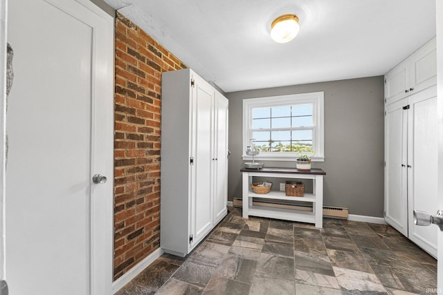 6830 County Road 40, Butler, IN 46721 - entrance foyer with baseboard heating, brick wall, and stone tile floors