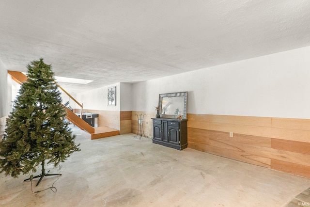 6830 County Road 40, Butler, IN 46721 - below grade area featuring wainscoting, stairs, and wooden walls