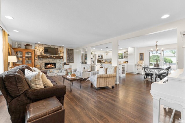 6830 County Road 40, Butler, IN 46721 - living room with a stone fireplace, a chandelier, dark wood-style flooring, and recessed lighting