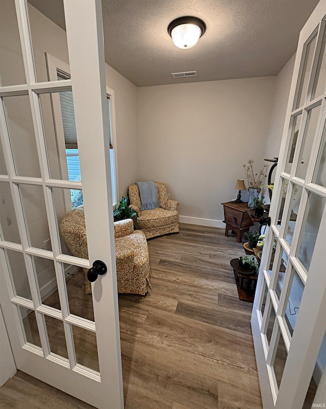 9 Beacon Way, Washington, IN 47501 - sitting room featuring french doors, wood finished floors, and a textured ceiling