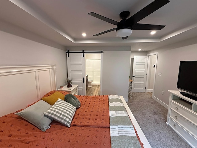 9 Beacon Way, Washington, IN 47501 - bedroom featuring a barn door, a raised ceiling, carpet floors, recessed lighting, and ensuite bathroom