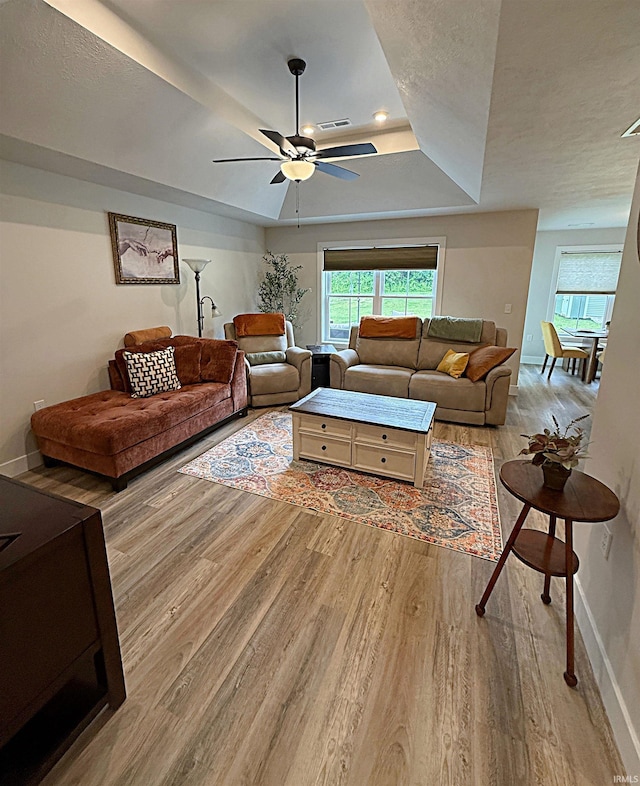 9 Beacon Way, Washington, IN 47501 - living room with a tray ceiling, light wood-style flooring, a ceiling fan, plenty of natural light, and a textured ceiling