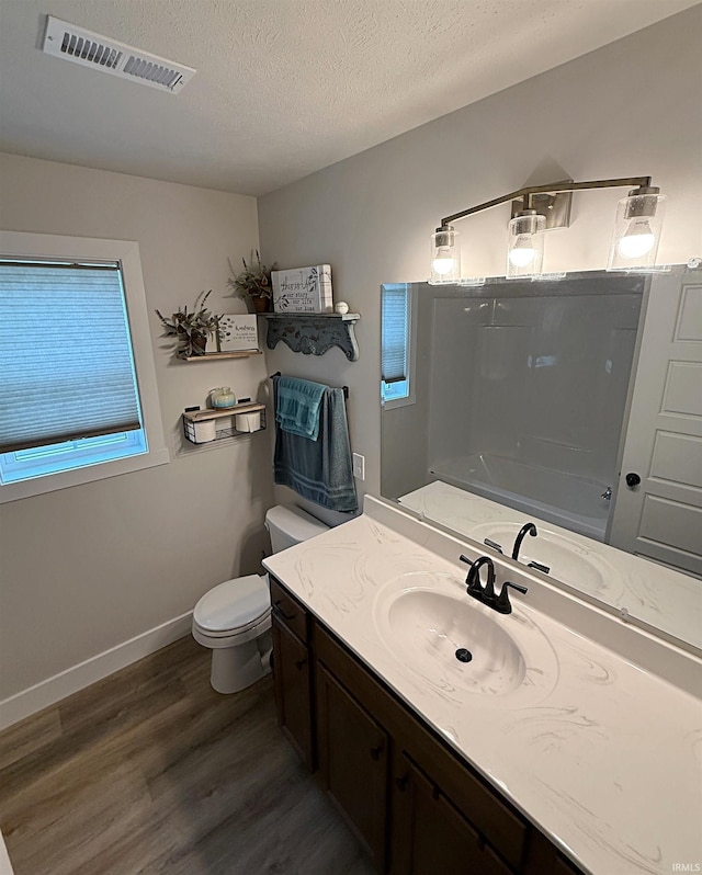 9 Beacon Way, Washington, IN 47501 - full bathroom featuring wood finished floors, vanity, a textured ceiling, and shower / tub combination