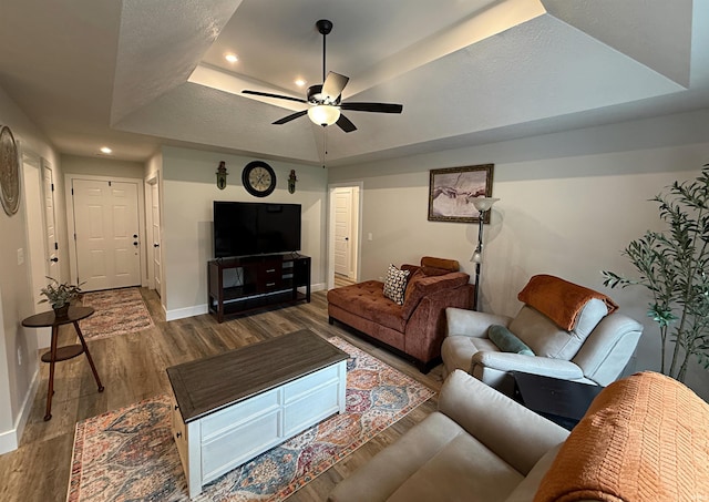 9 Beacon Way, Washington, IN 47501 - living room featuring a tray ceiling, ceiling fan, wood finished floors, and recessed lighting