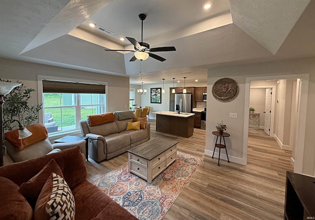 9 Beacon Way, Washington, IN 47501 - living room with a raised ceiling, light wood-style floors, and a ceiling fan