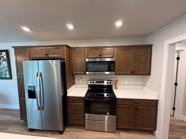 9 Beacon Way, Washington, IN 47501 - kitchen with stainless steel appliances, light wood-style flooring, light countertops, and recessed lighting