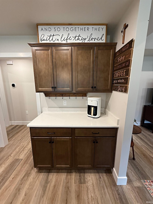 9 Beacon Way, Washington, IN 47501 - kitchen featuring light wood-style floors, dark brown cabinetry, and light countertops