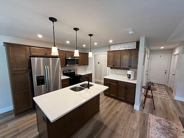 9 Beacon Way, Washington, IN 47501 - kitchen with stainless steel appliances, dark brown cabinetry, wood finished floors, pendant lighting, and recessed lighting