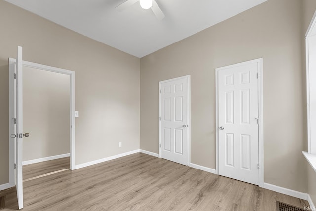 307 W Flora St, Washington, IN 47501 - unfurnished bedroom with light wood-style floors and ceiling fan