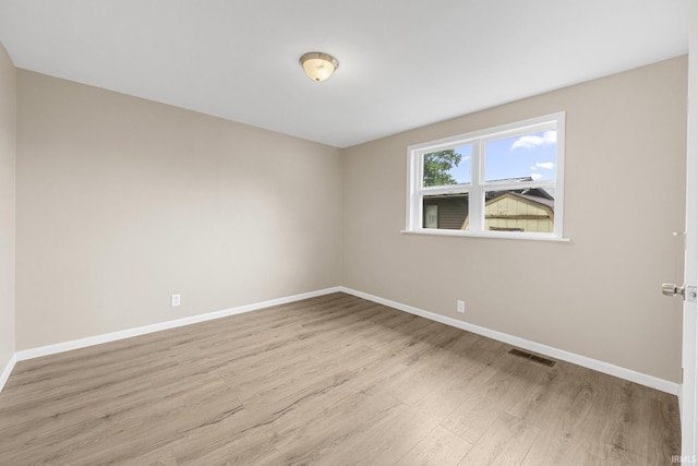 307 W Flora St, Washington, IN 47501 - unfurnished room with wood finished floors and baseboards