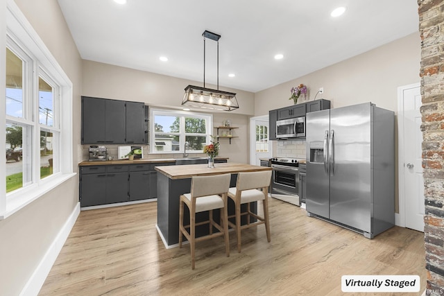 307 W Flora St, Washington, IN 47501 - kitchen with stainless steel appliances, butcher block countertops, light wood-style flooring, a kitchen island, and recessed lighting