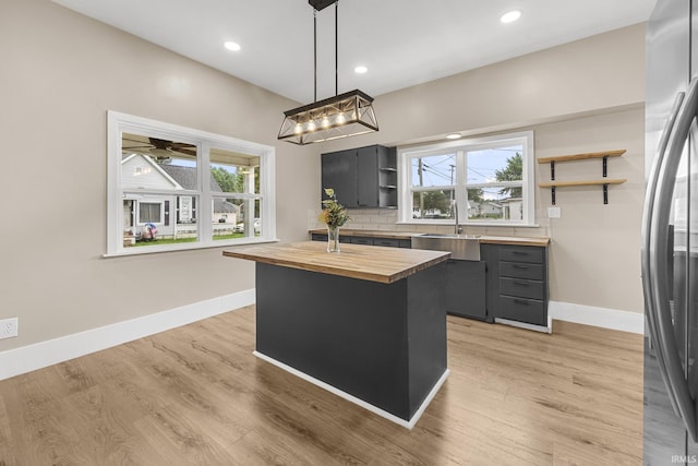307 W Flora St, Washington, IN 47501 - kitchen with butcher block countertops, open shelves, freestanding refrigerator, healthy amount of natural light, and recessed lighting
