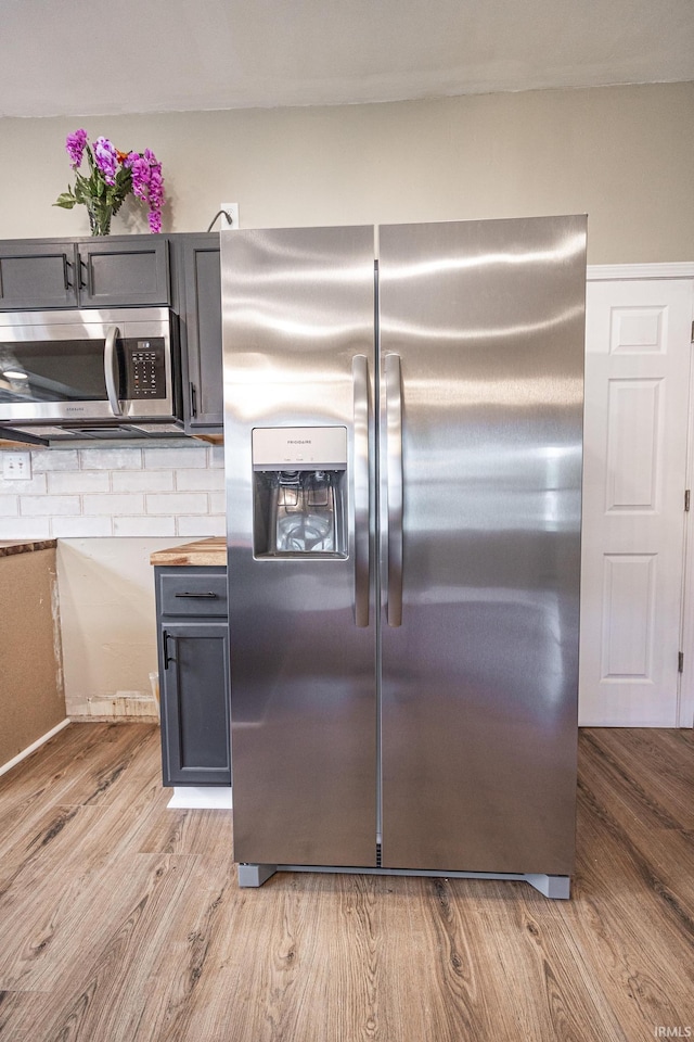 307 W Flora St, Washington, IN 47501 - kitchen with stainless steel appliances, light wood-style floors, gray cabinets, and butcher block counters