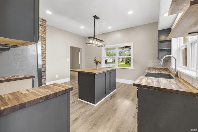 307 W Flora St, Washington, IN 47501 - kitchen with butcher block counters, light wood-type flooring, a kitchen island, recessed lighting, and pendant lighting