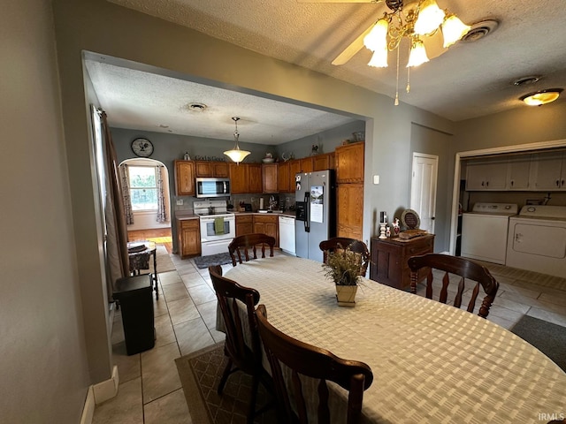 1114 W 4th St, Marion, IN 46952 - dining space featuring washer and clothes dryer, a textured ceiling, ceiling fan, light tile patterned floors, and arched walkways