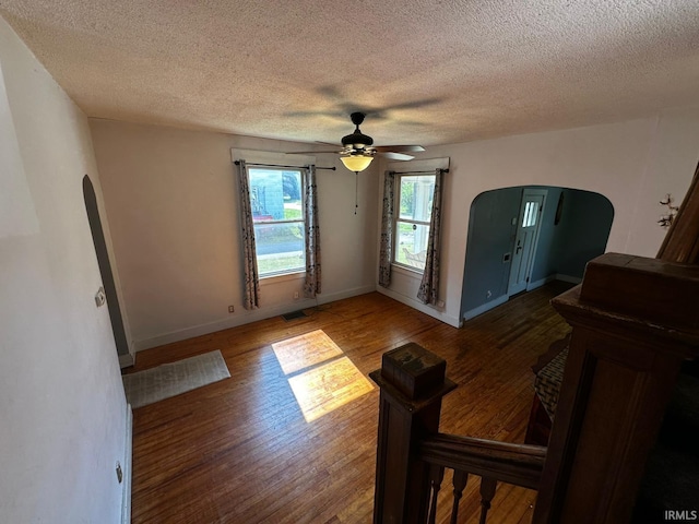 1114 W 4th St, Marion, IN 46952 - unfurnished room featuring arched walkways, wood finished floors, a textured ceiling, and ceiling fan