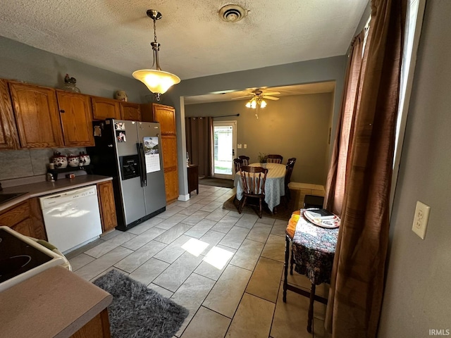 1114 W 4th St, Marion, IN 46952 - kitchen featuring stainless steel fridge with ice dispenser, white dishwasher, brown cabinets, decorative light fixtures, and ceiling fan