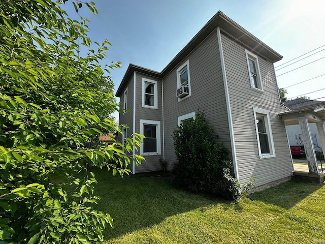 1114 W 4th St, Marion, IN 46952 - view of side of home featuring a lawn and cooling unit