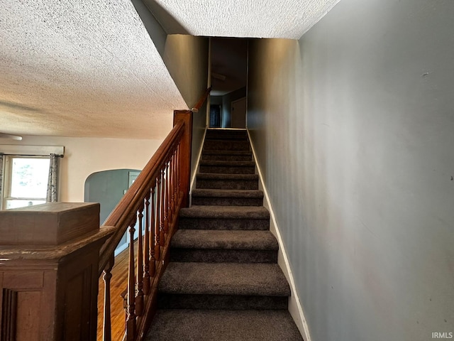 1114 W 4th St, Marion, IN 46952 - stairway with a textured ceiling, arched walkways, and carpet flooring
