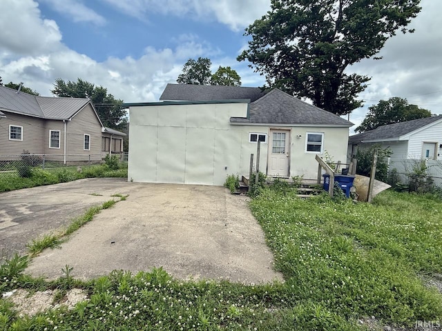 313 N Embree St, Princeton, IN 47670 - view of front of house with a shingled roof and stucco siding