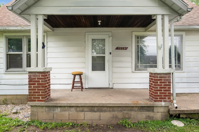 1614 E 24th St, Muncie, IN 47302 - doorway to property featuring a porch and a shingled roof